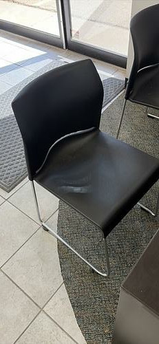Black molded plastic chairs