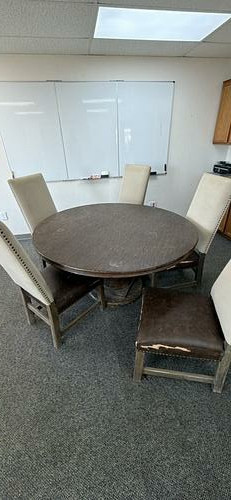 Round meeting table with five chairs