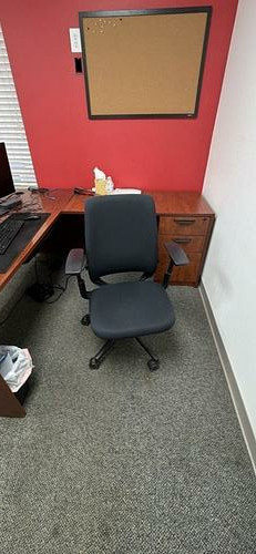 Black upholstered rolling office chair
