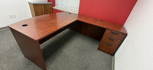 Large wood-look office desk with return