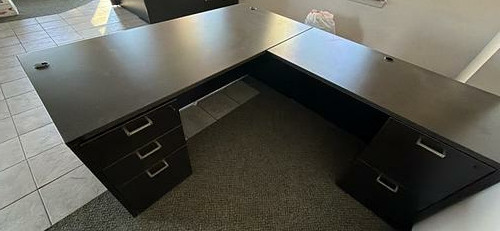 Large dark five-drawer office desk with key