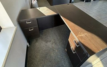 Large dark four-drawer office desk